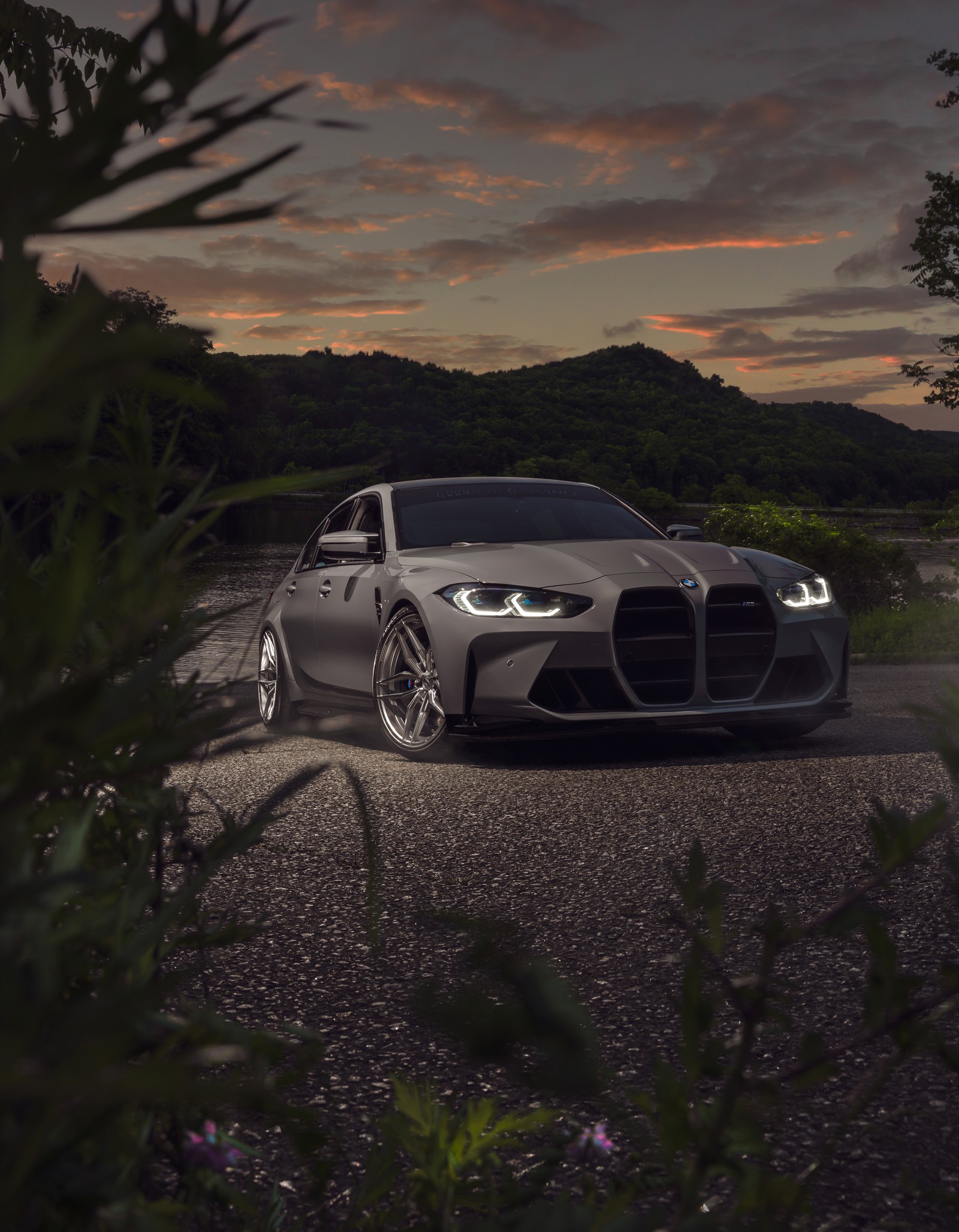 A close up of a car parked on a road near a forest (bmw m3, luxury sedan, 5k, cars, 4k wallpaper)