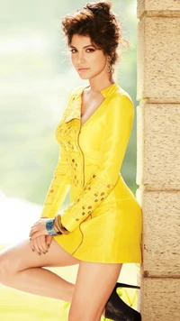 Anushka Sharma in a vibrant yellow dress, showcasing high heels and a stylish pose.