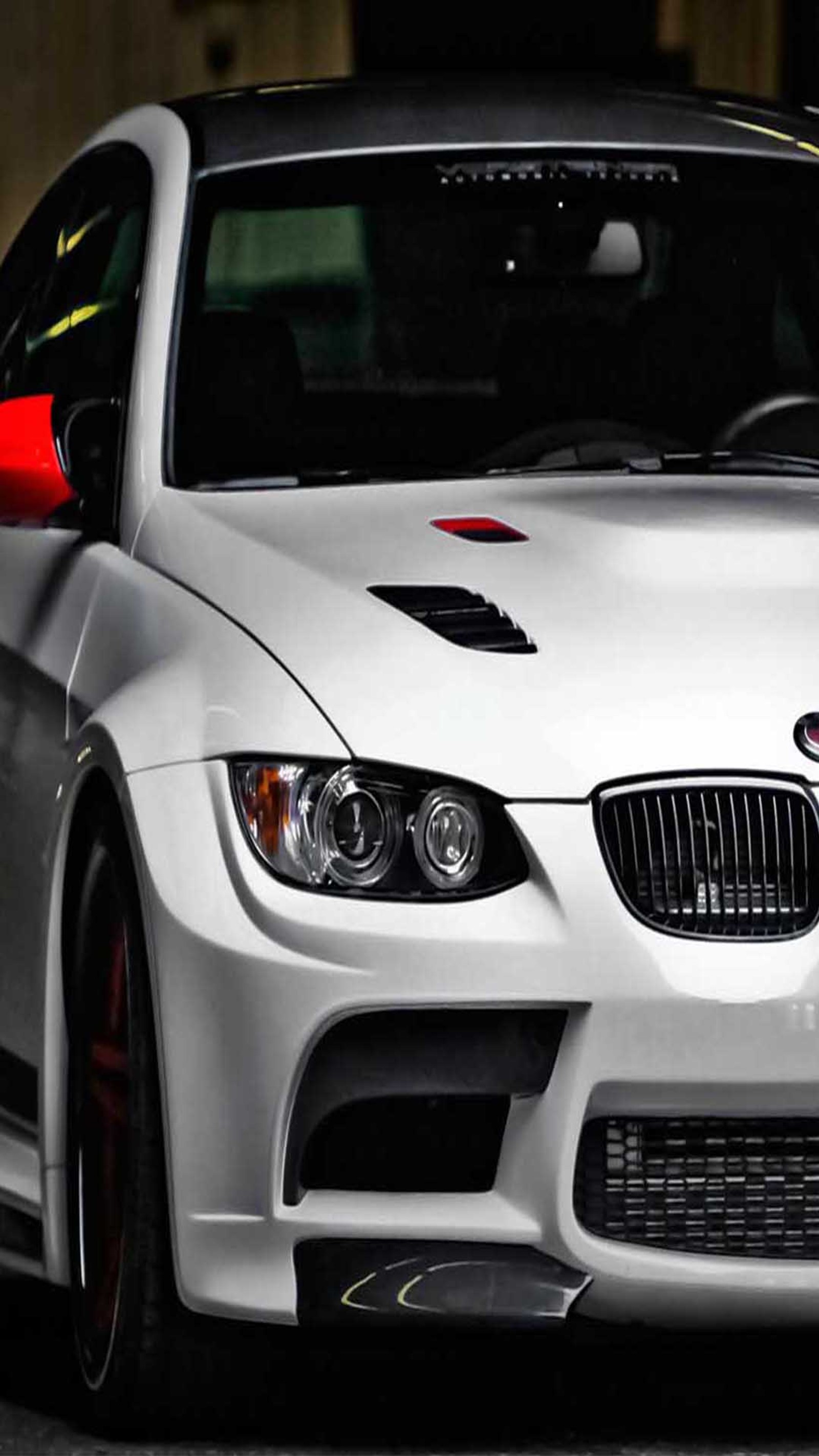 Arafed white car with red stripes parked in a parking garage (bmw, m3)