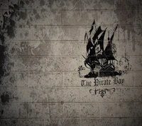 Graffiti d'un navire pirate sur un mur de briques usé, avec le texte "La Baie des Pirates".