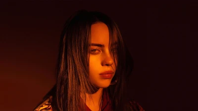 Billie Eilish in a dramatic, warm-toned portrait.