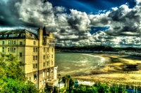 Grand Hotel Overlooking Cloudy Beach Landscape