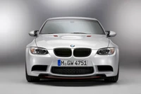 Sleek silver BMW M3 with a bold front grille and sporty design.