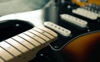 Close-up view of an electric guitar showcasing the fretboard and pickups.