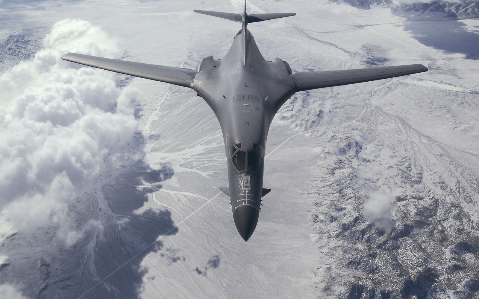 Arafed jet flying over a mountain range with clouds (rockwell b 1 lancer, aircraft, military aircraft, strategic bomber, united states air force)