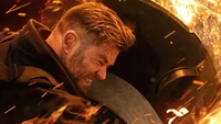 Chris Hemsworth in a fiery action scene from "Extraction 2" on Netflix (2023).