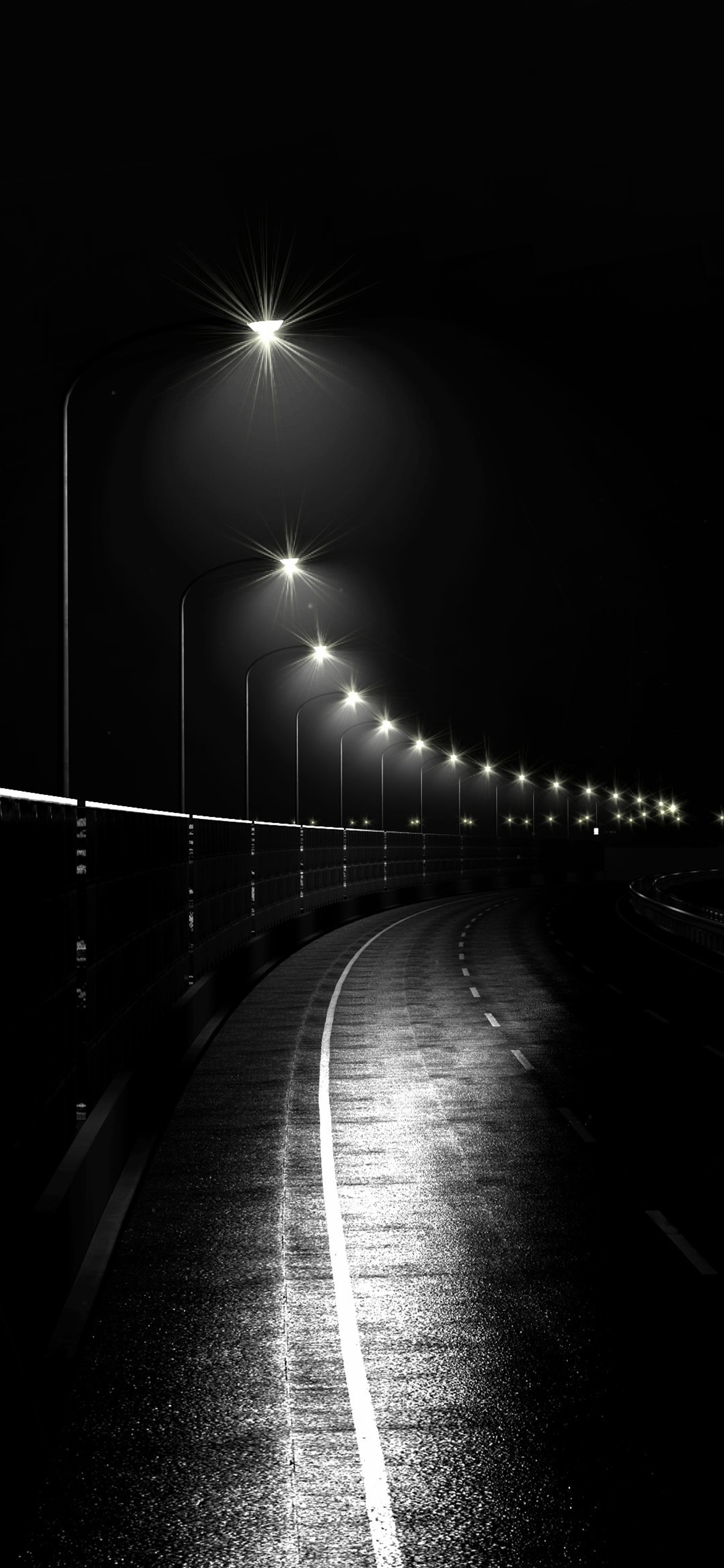 Vista de una calle con faroles y una larga fila de luces (noche, tierra, farola, lámpara, atmósfera)