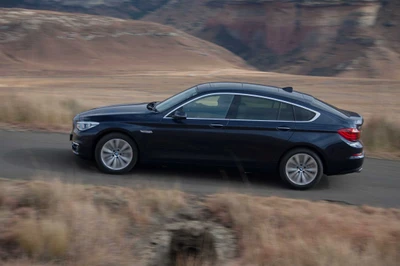 BMW 3 Series Gran Turismo Driving Through Scenic Landscape