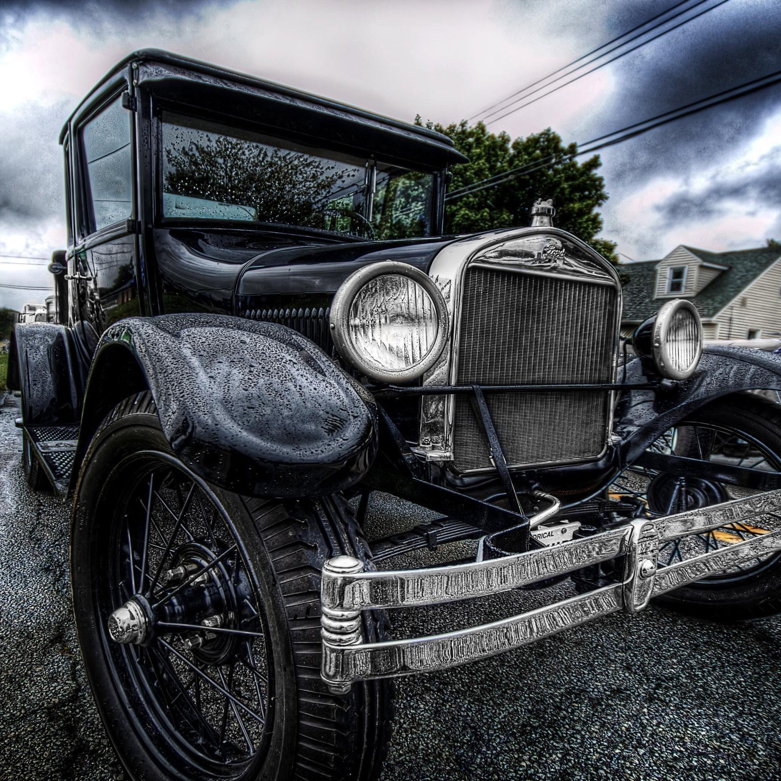 There is a old car parked on the side of the road (bc, gw)