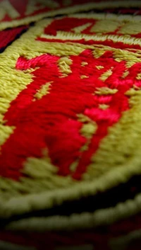 Embroidered Logo with Red and Yellow Design