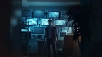 Atmospheric Scene of a Character Surrounded by Surveillance Monitors in a Dimly Lit Room