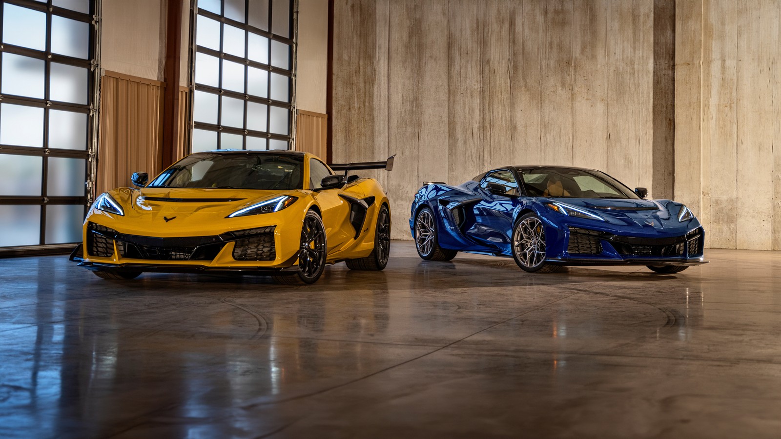 Two yellow and blue sports cars parked in a garage (chevrolet corvette zr1, 5k, 2025, cars, 4k wallpaper)