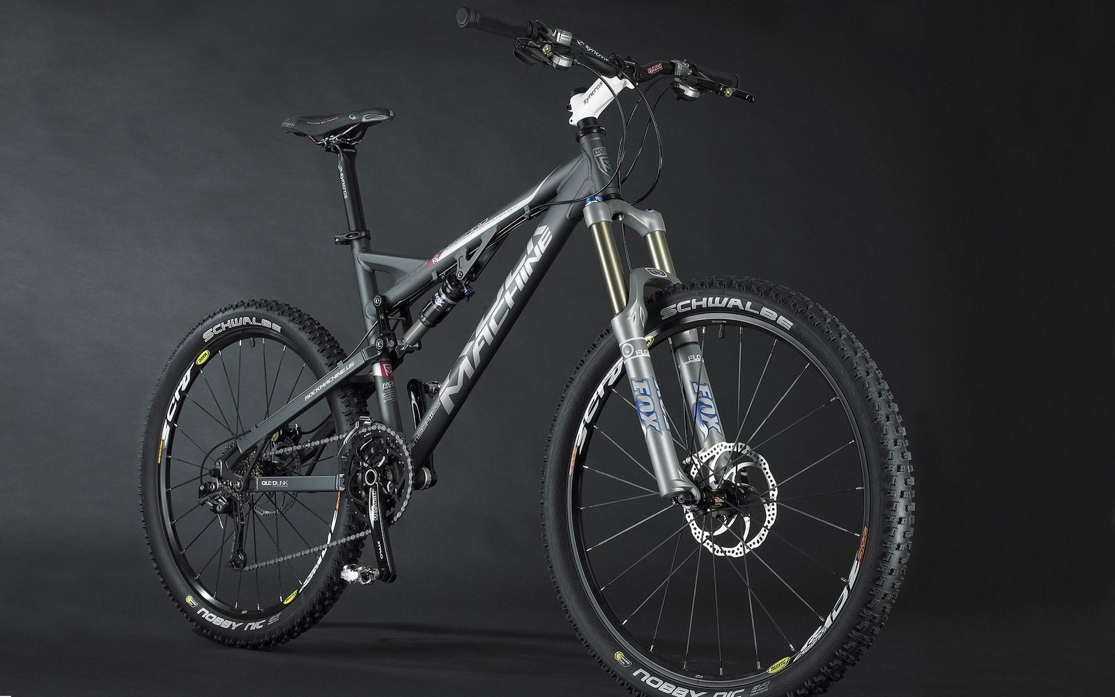 A close up of a bike on a black background with a black background (bicycle, gray, sports, metal)