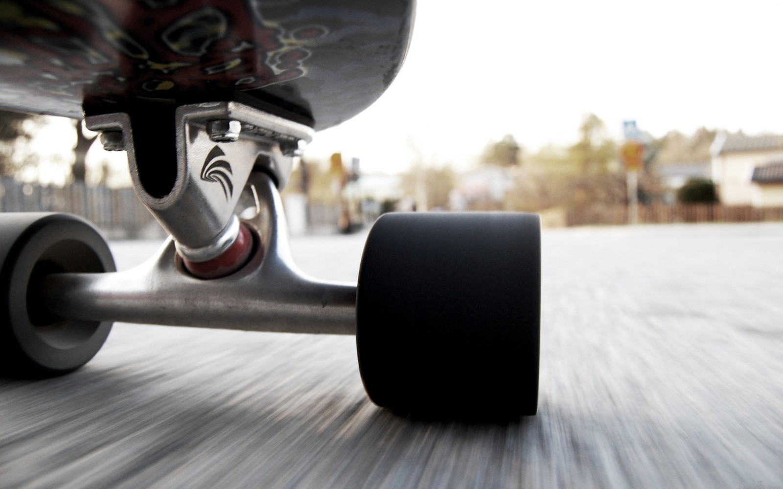 Arafed view of a skateboard with wheels on a street (skateboard, skateboarding, vans, sports equipment)