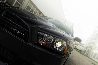 Sleek Black Rolls Royce with Distinctive Headlamps and Grille Design