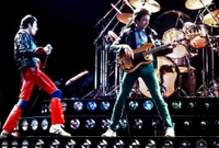 Freddie Mercury and the band Queen electrifying the stage during a rock concert performance.