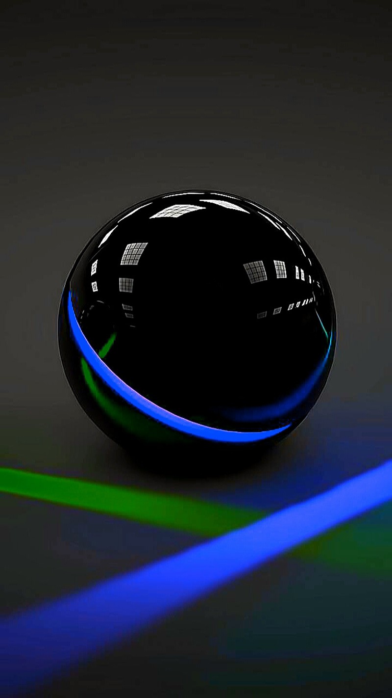 There is a black sphere with a blue light on it (black, orb)