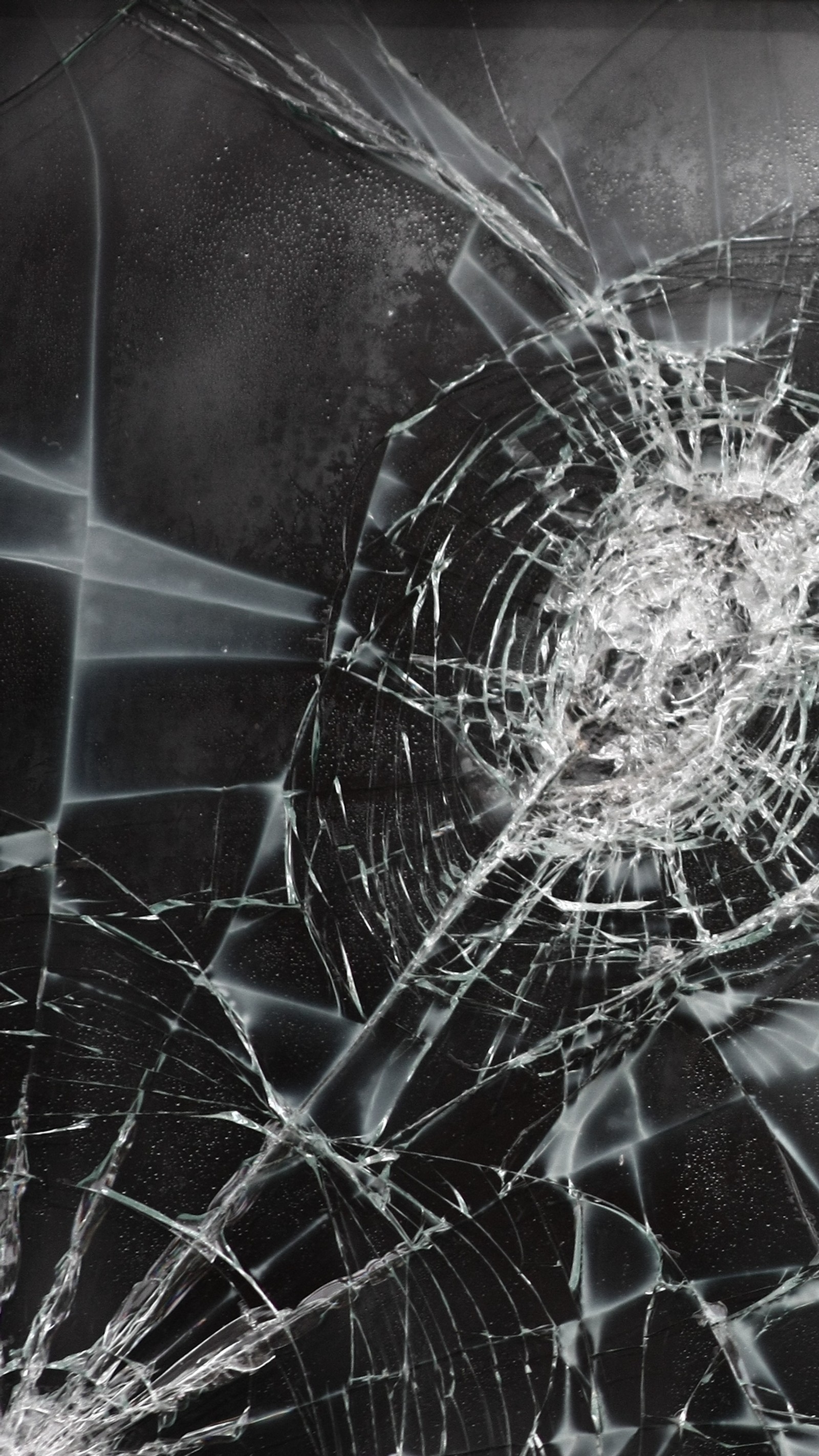 A close up of a broken glass window with a hole in it (abstract, awesome, broken, cool, cracked)