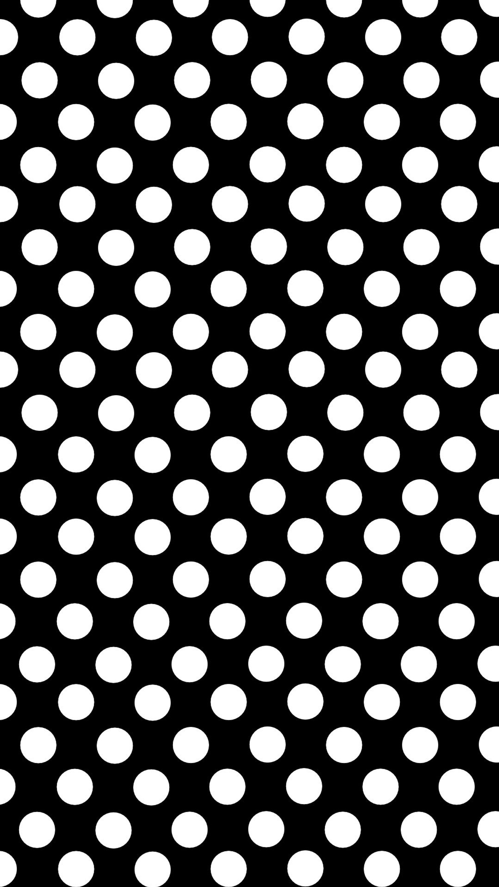 Un motif à pois noir et blanc sur un fond noir (pois, petit)