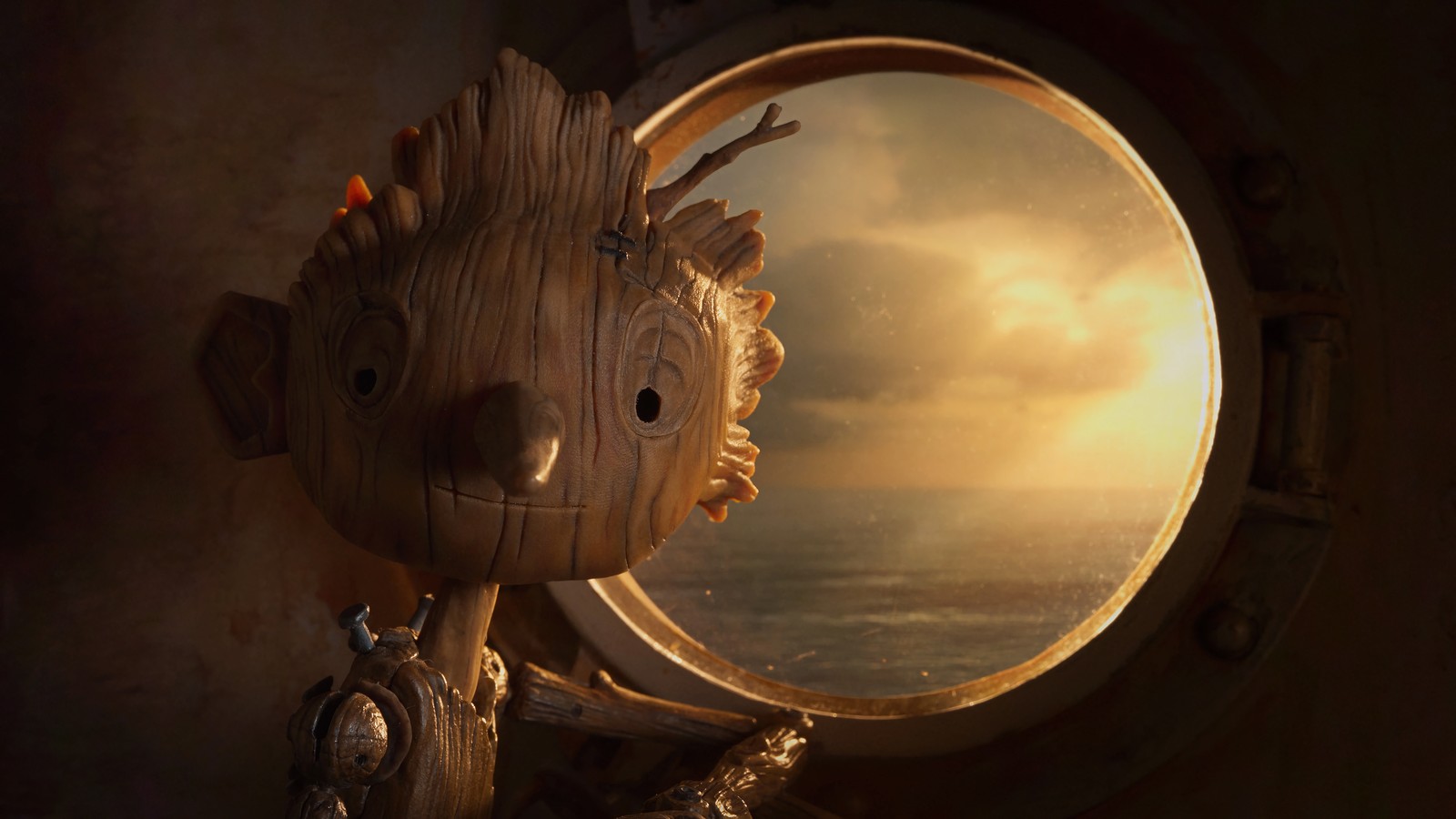 There is a wooden statue of a grooter looking out a window (guillermo del toros pinocchio, movie, netflix, pinocchio)