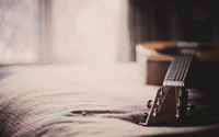 Acoustic Guitar on a Soft Surface with Natural Light