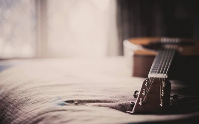 Acoustic Guitar on a Soft Surface with Natural Light