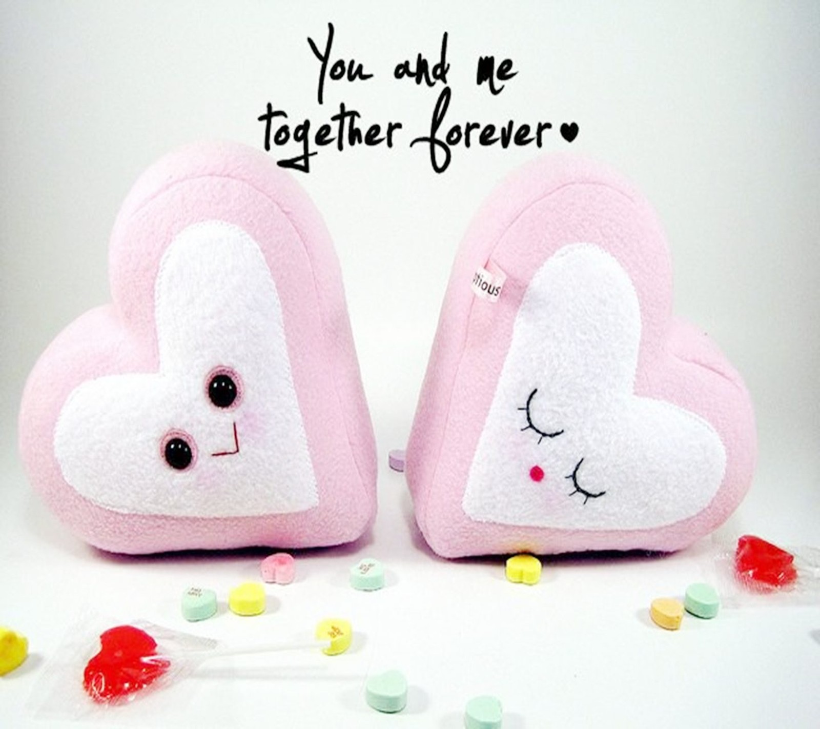 There are two pink heart shaped pillows with a message on them (couple, emo, heart, i love you, i miss you)