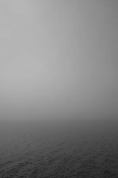 Misty Horizon Over Calm Waters