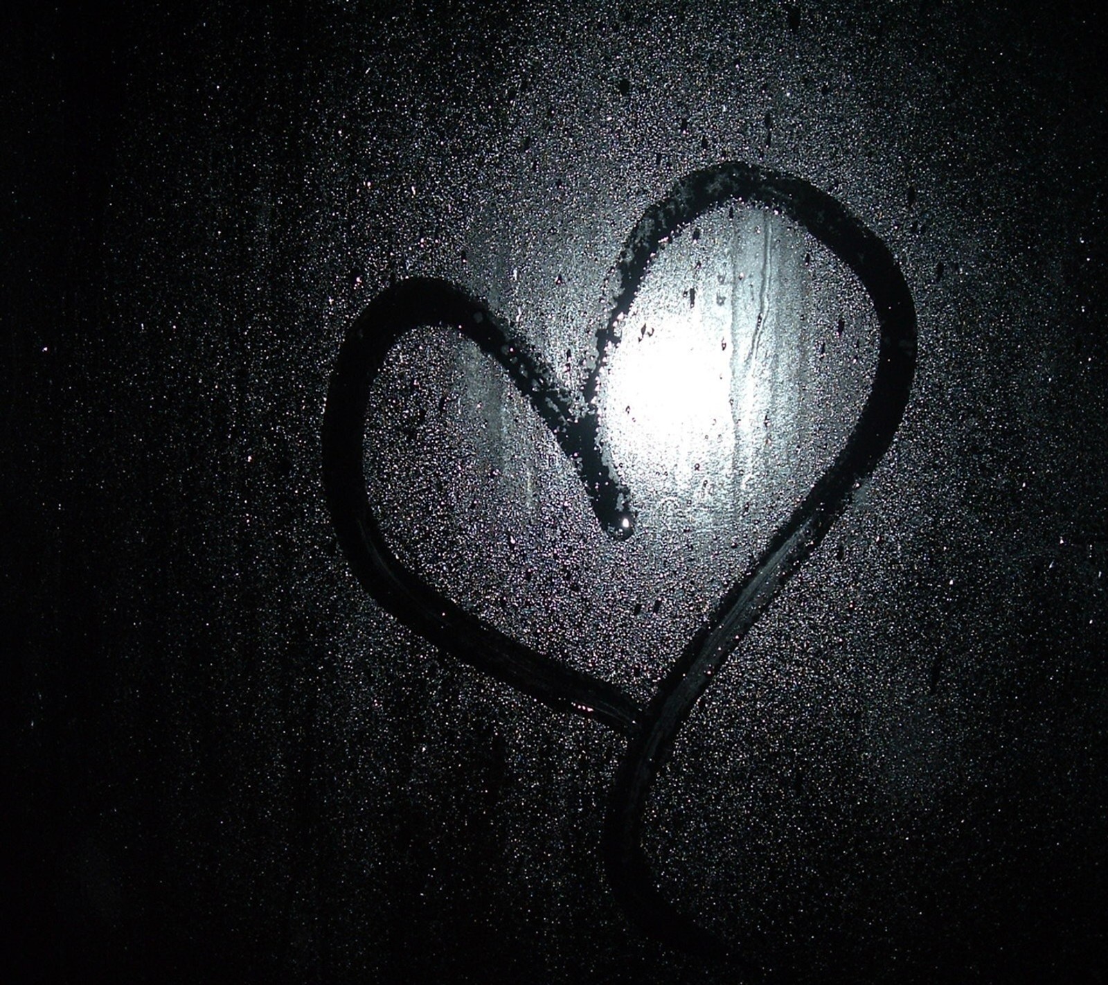 Arafed heart drawn on a window with a black background (black, glass, heart, love, rain)