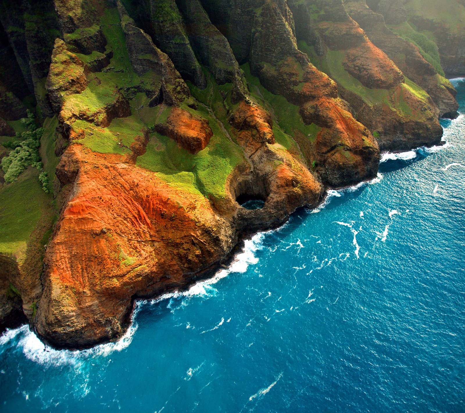 A view of a cliff with a body of water near it (cliff, mountain, ocean, sea, water)