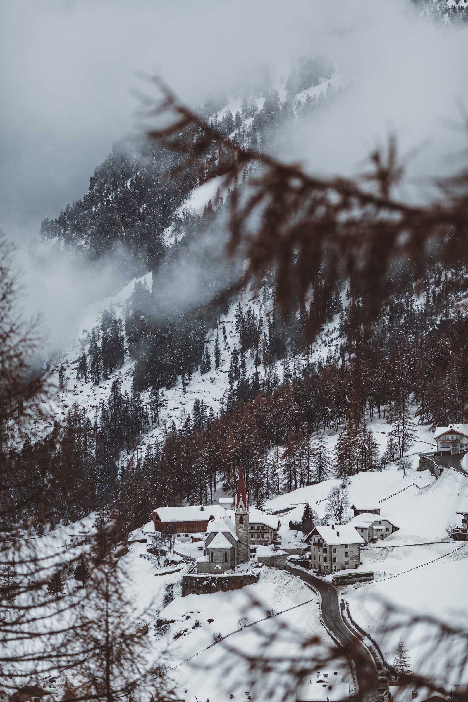 Snowy mountain landscape with a church and a road in the foreground (winter, snow, tree, water, natural landscape)