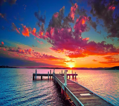 Sunset Over Tranquil Waters with a Wooden Pier