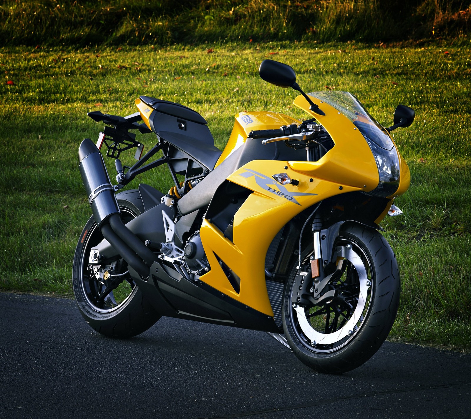 Yellow motorcycle parked on the side of the road in the grass (grass, motorbike, yellow)