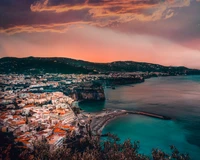 Scenic Coastal Bay at Dusk with Vibrant Sky and Charming Architecture