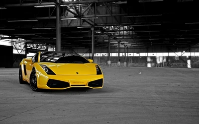 Yellow Lamborghini Gallardo parked in an industrial setting, showcasing its sleek design and sporty appeal.