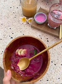 Colorful Purple Dish with Banana Slices and Golden Spoon