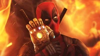 Deadpool mit dem Infinity-Handschuh vor einem feurigen Hintergrund