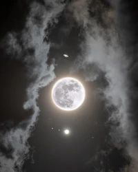 Celestial Harmony: Full Moon Surrounded by Cumulus Clouds