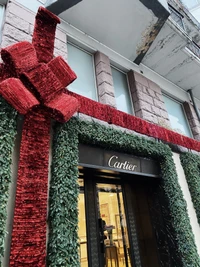 Festive Cartier Facade Adorned in Red and Green