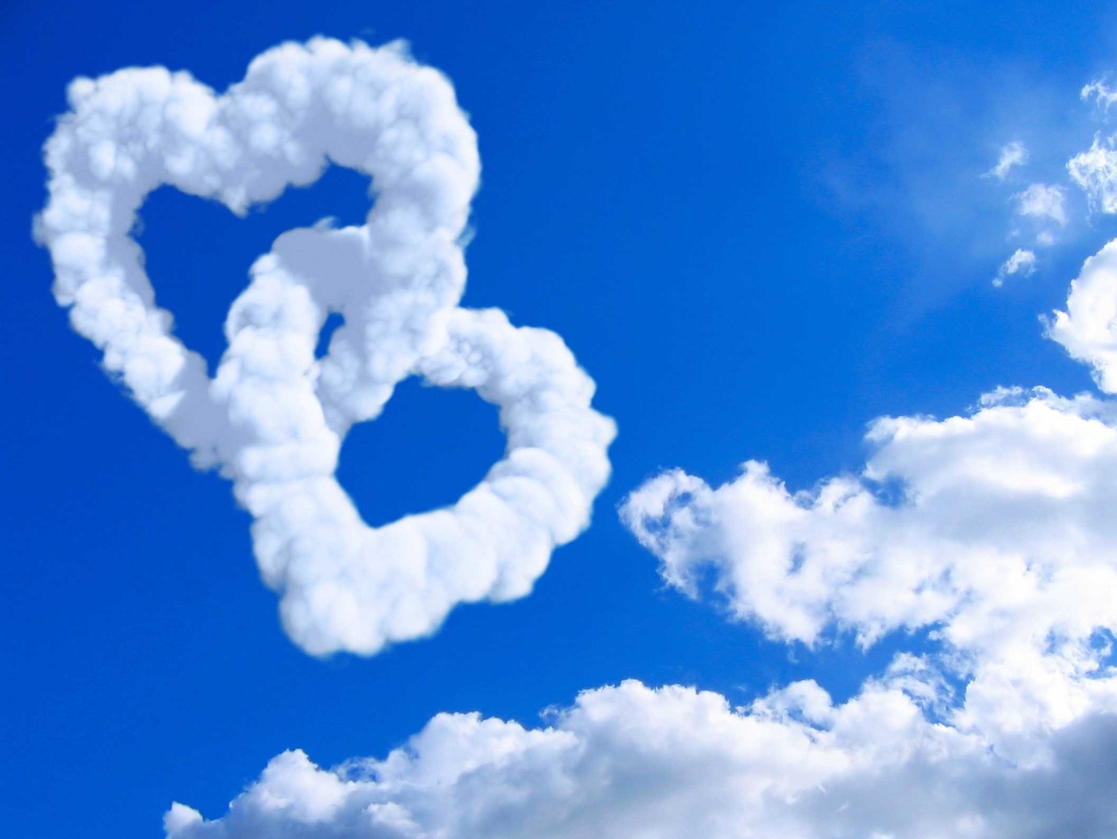 There are two heart shaped clouds in the shape of a heart (awesome, love)