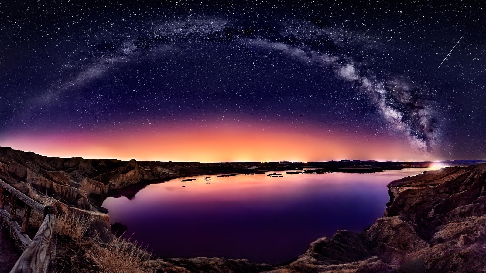 Uma vista de um lago com um céu roxo brilhante e um céu cheio de estrelas (paisagem, noite, céu, estrelas, cenário)