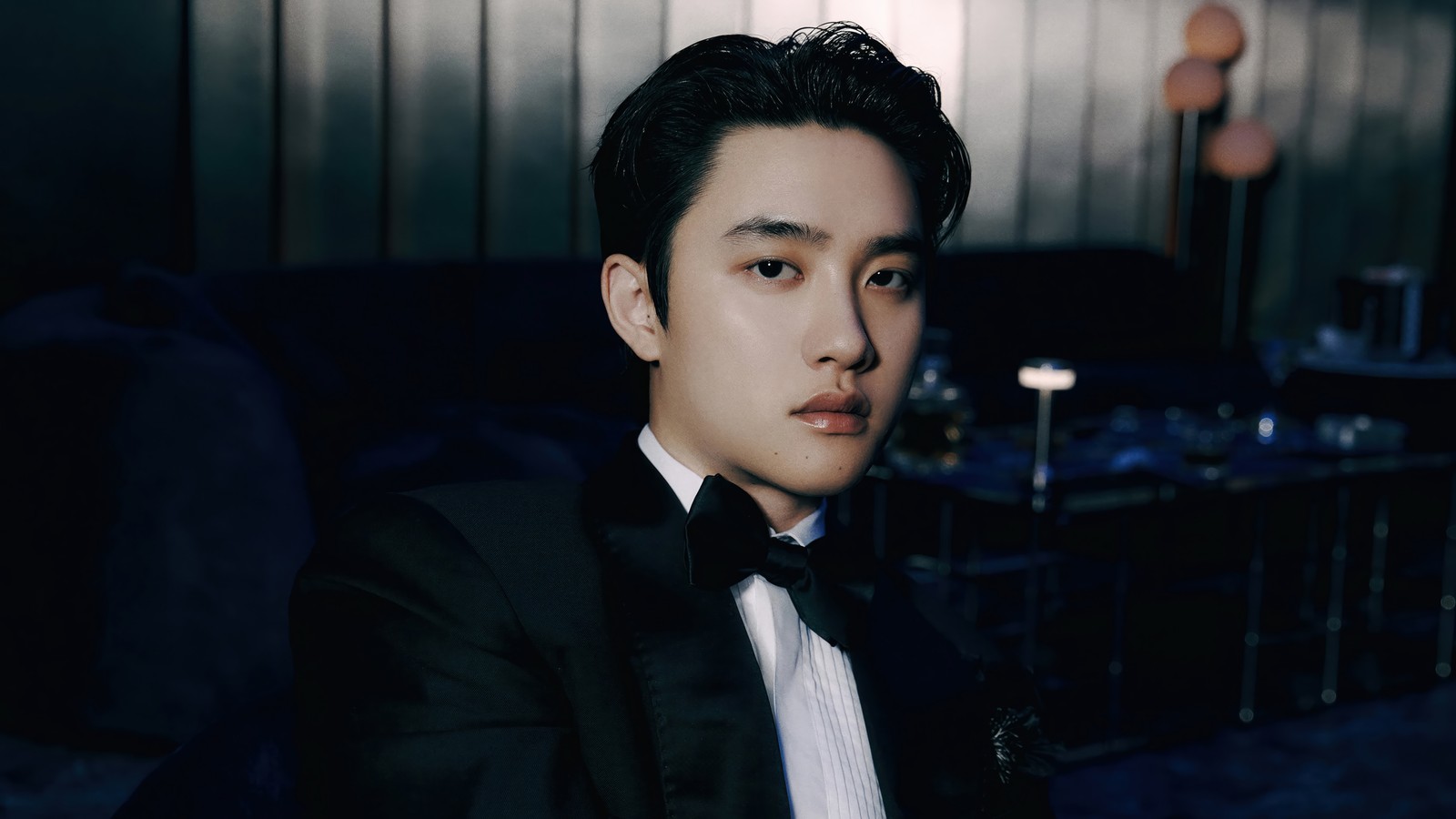 There is a man in a tuxedo sitting in a chair (do, 디오, do kyung soo, 도경수, exo)