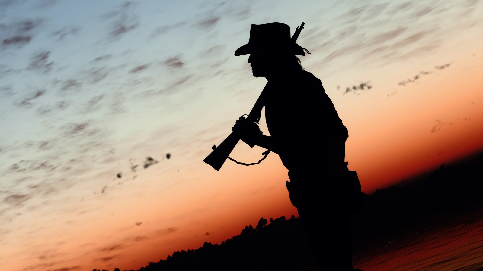 Silhouette d'un homme avec une arme à la main au coucher du soleil (ouest, cow boy, coucher de soleil, silhouette, red dead redemption)