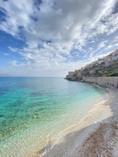 Azure Waters and Kizilkule Under Cumulus Clouds