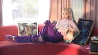 Jeon Somi Relaxing on a Couch in Vibrant Fashion