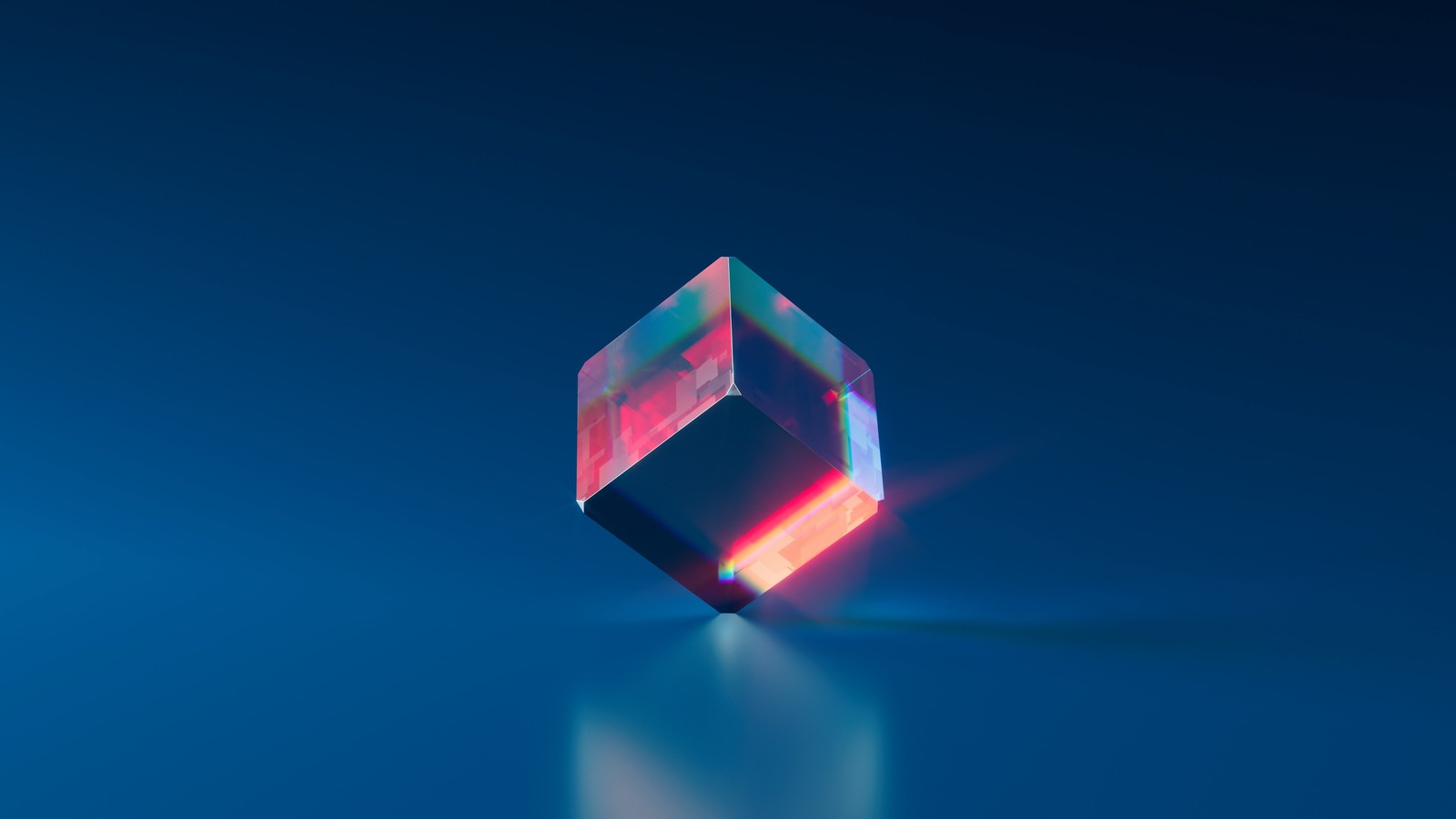 A close up of a crystal on a blue surface with a light (cube, crystal, blue, rectangle, triangle)