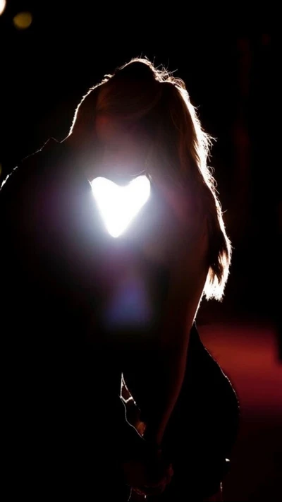 Couple Kissing with Heart-Shaped Light at Night