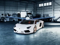 White Lamborghini Aventador in a spacious hangar with a plane in the background.