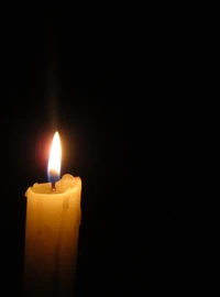 Solitary Candle Illuminating the Darkness