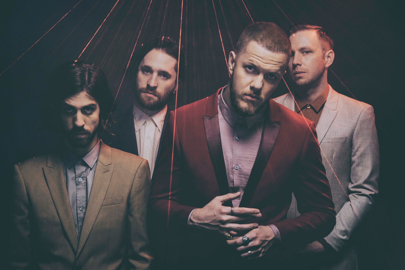 Arafed image of a group of men in suits standing together (musical ensemble, facial hair, suit, beard, fashion)